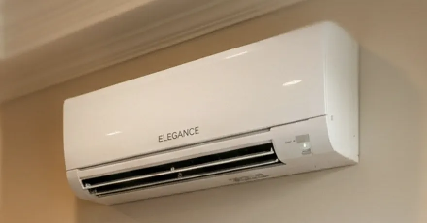 Wall-mounted ductless mini split air handler in a home hallway